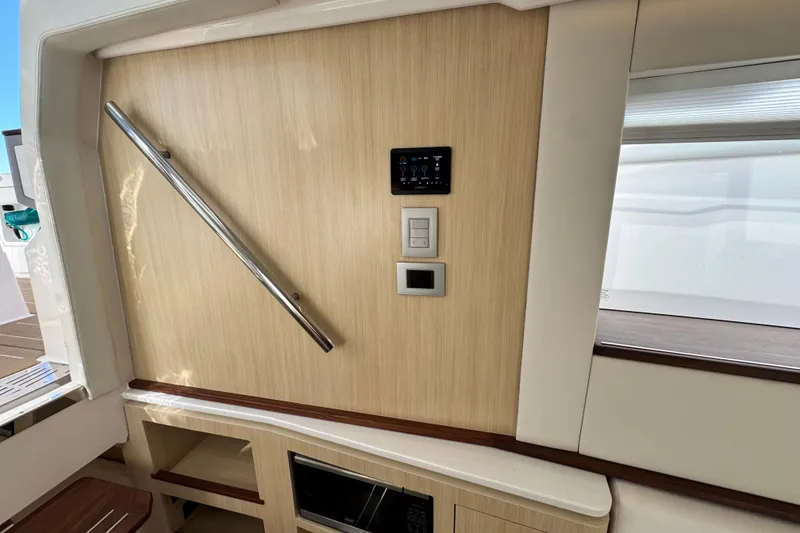 Slide: The Image of Interior of 2025 Regal LX43 yacht with modern control panel and sleek design. - 46