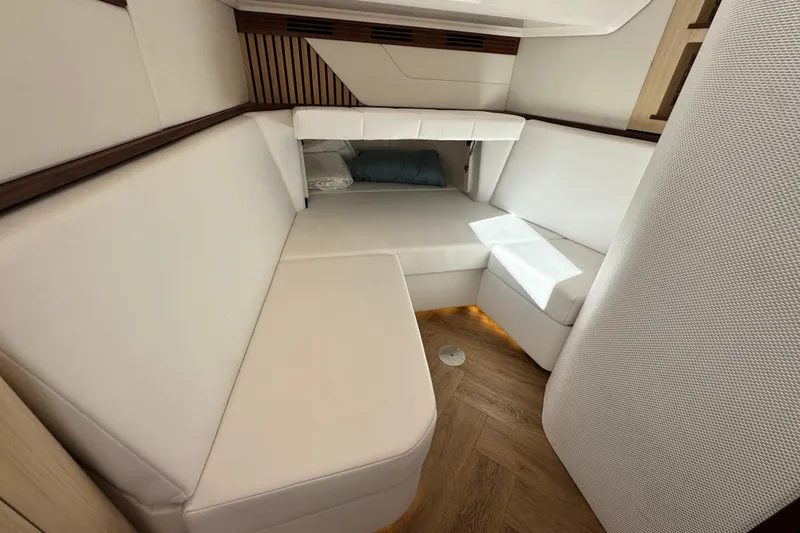 Slide: The Image of Luxurious interior of 2025 Regal LX43 yacht with white seating and wood accents. - 47