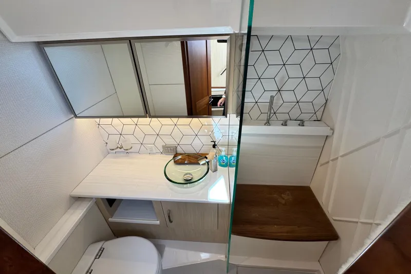 Slide: The Image of Modern bathroom in 2025 Regal LX43 yacht with geometric tiles and glass sink. - 48