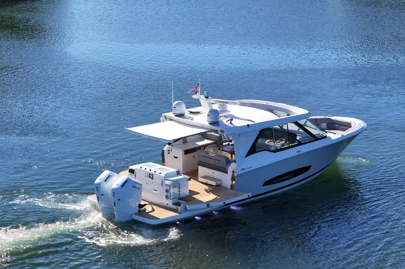 Slide: The Image of 2025 Regal LX43 luxury boat cruising on serene blue waters. - 5