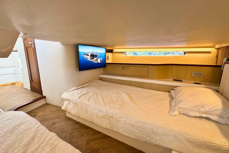 Slide: The Image of Luxurious cabin interior of 2025 Regal LX43 yacht with cozy bedding and modern amenities. - 51