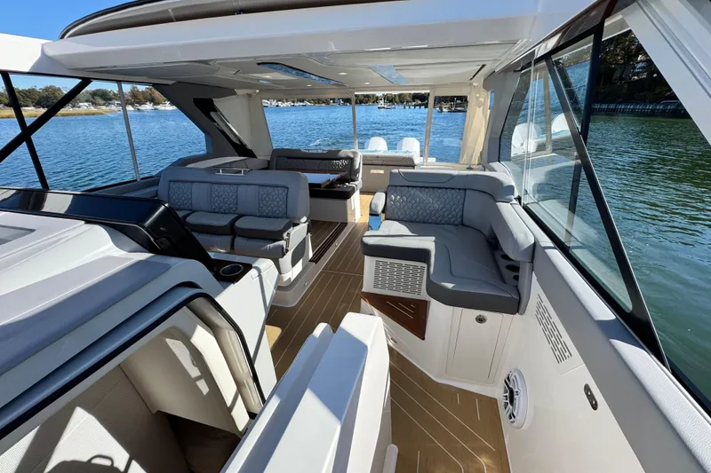Slide: The Image of Luxurious 2025 Regal LX43 yacht interior with elegant seating and scenic water views. - 53