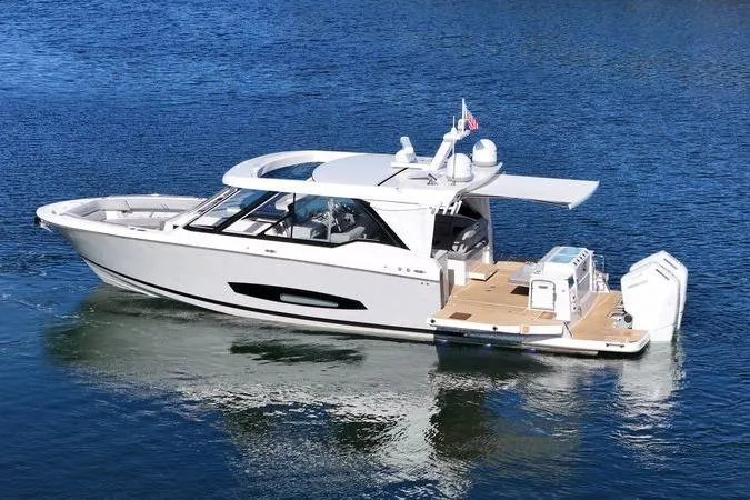 Slide: The Image of 2025 Regal LX43 luxury yacht on calm blue water, showcasing sleek design and modern features. - 7
