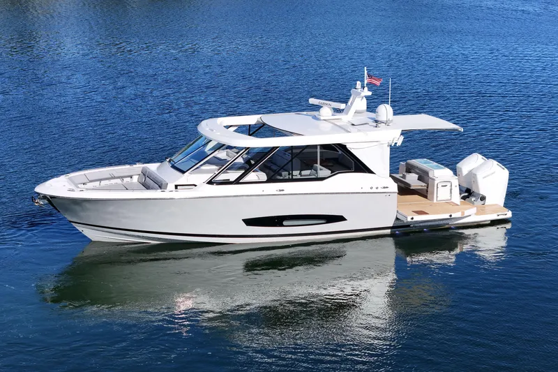Slide: The Image of 2025 Regal LX43 luxury boat on calm blue water, showcasing sleek design and modern features. - 8