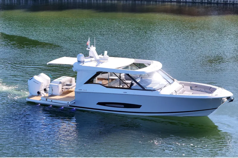 Slide: The Image of 2025 Regal LX43 luxury boat cruising on calm waters. - 9