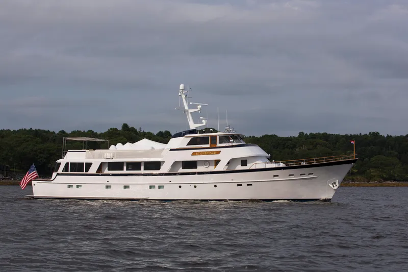 The Image of Vintage 1978 Burger Custom yacht cruising on open sea under clear skies. - 0
