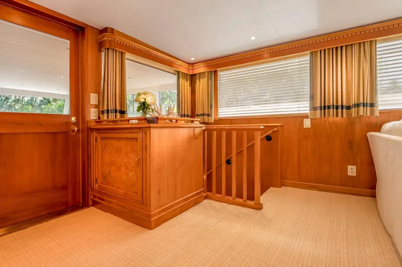 Slide: The Image of Luxurious wooden interior of a 1978 custom Burger yacht with elegant decor and natural light. - 17