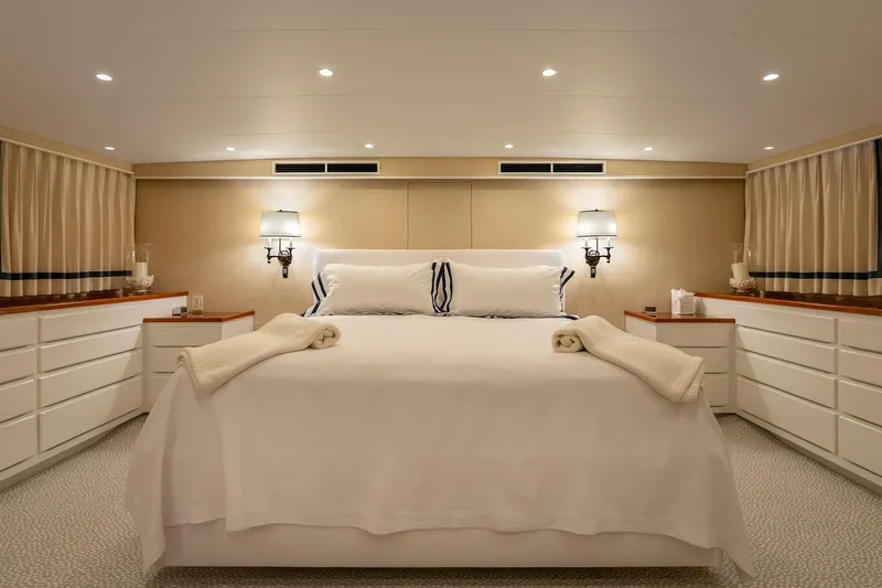 Slide: The Image of Luxurious yacht bedroom with elegant lighting, white bedding, and ample storage, Burger Custom 1978. - 18