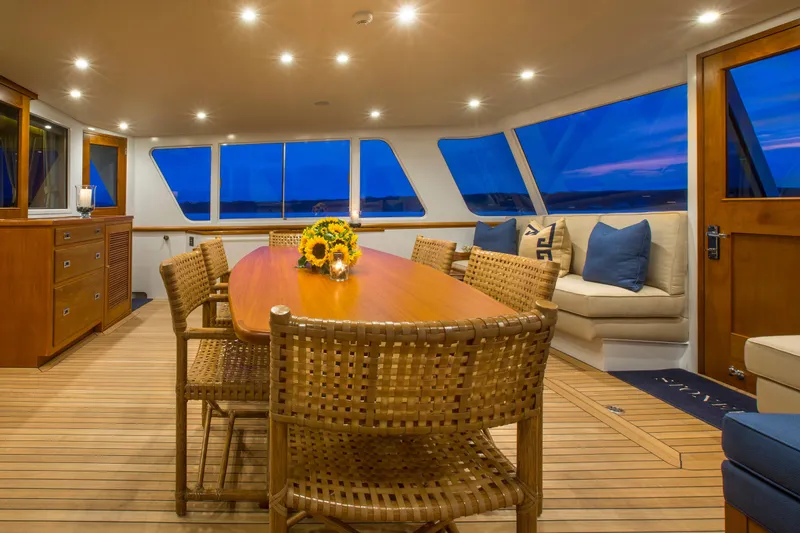 Slide: The Image of Luxurious 1978 Burger Custom yacht interior with elegant dining area and scenic waterfront views. - 2