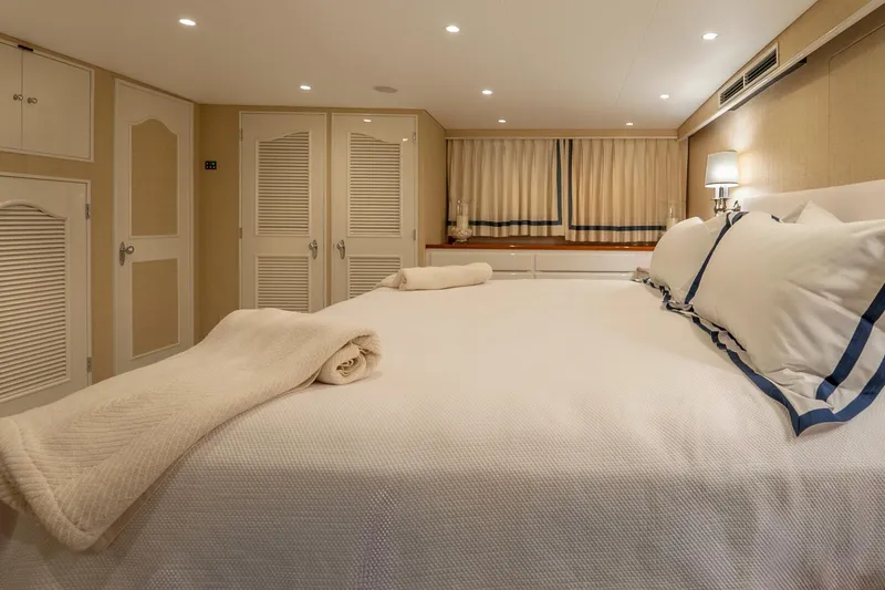 Slide: The Image of Luxurious bedroom interior on a 1978 custom Burger yacht, featuring elegant bedding and soft lighting. - 20