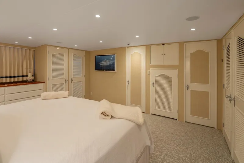 Slide: The Image of Luxurious yacht bedroom with elegant decor, featuring a comfortable bed and ample storage, 1978 Burger Custom. - 21