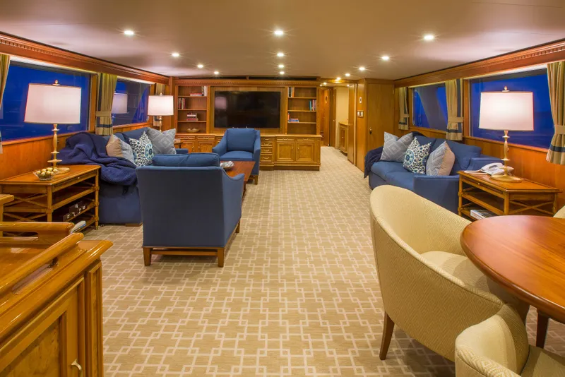 Slide: The Image of Elegant dining setup on a 1978 Burger Custom yacht with waterfront view. - 3