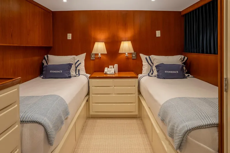Slide: The Image of Twin beds in a cozy 1978 Burger Custom yacht cabin with warm wood paneling. - 31
