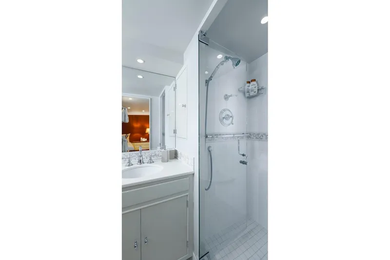 Slide: The Image of Modern bathroom with glass shower, white vanity, and elegant fixtures. - 33