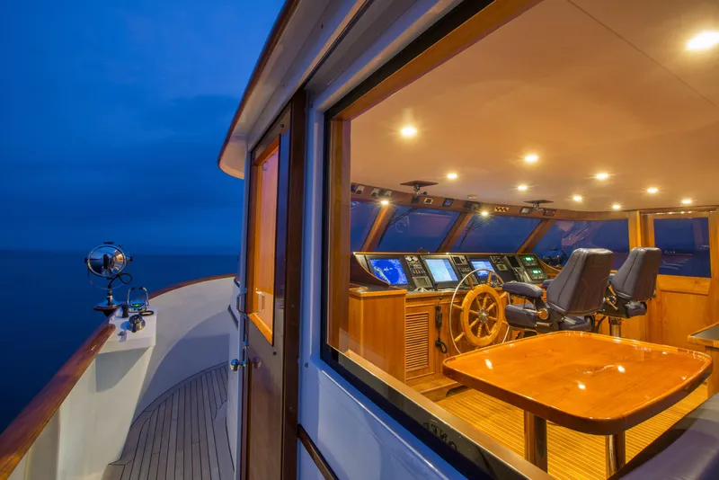 Slide: The Image of Luxurious 1978 Burger Custom yacht interior with illuminated helm and ocean view. - 37