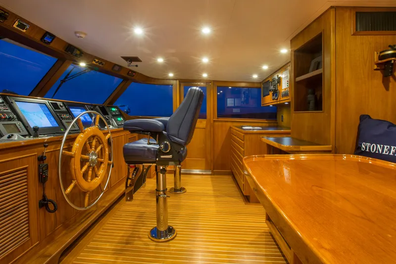 Slide: The Image of Luxurious 1978 Burger Custom yacht interior with wooden helm and modern navigation equipment. - 38
