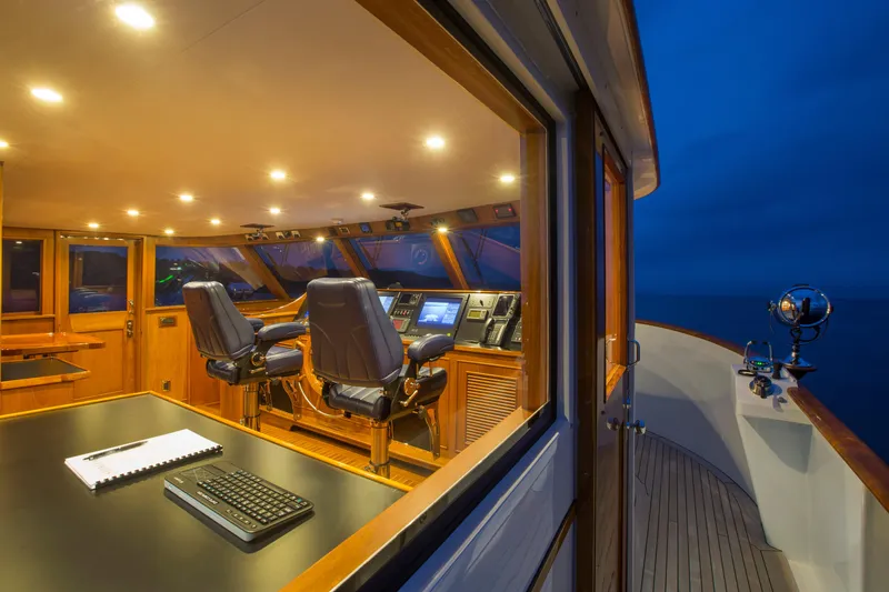 Slide: The Image of Luxurious 1978 Burger Custom yacht interior with modern navigation equipment and elegant wood finish. - 39