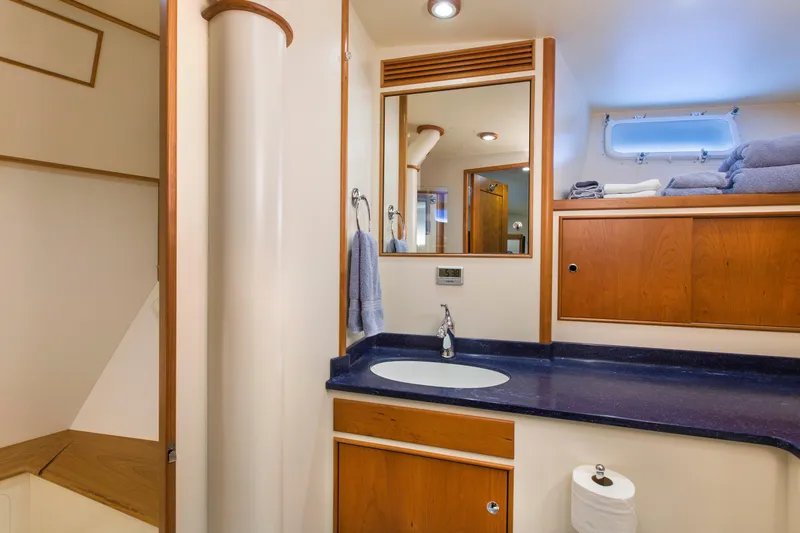 Slide: The Image of Luxurious yacht bathroom with wooden cabinets, blue countertop, and modern fixtures, 1978 Burger Custom. - 45