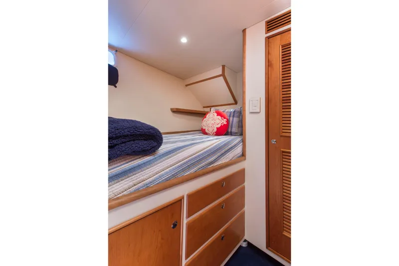 Slide: The Image of Cozy cabin interior with striped bedding and wooden storage, 1978 Burger Custom yacht. - 47