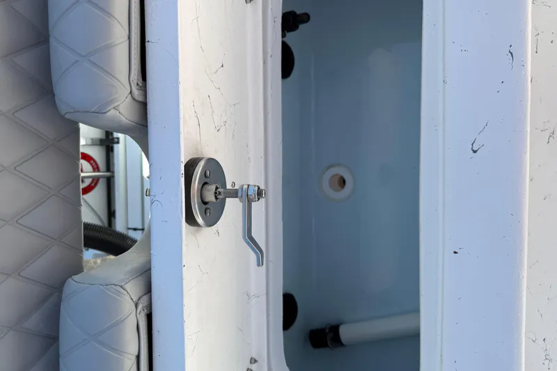 Slide: The Image of Interior view of 2026 Blazer Bay 2400 boat compartment with latch and cushioned seating. - 12