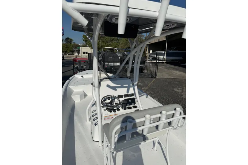 Slide: The Image of 2026 Blazer Bay 2400 boat interior with steering console and rod holders. - 16