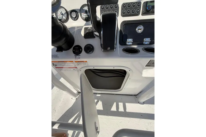 Slide: The Image of 2026 Blazer Bay 2400 boat console with gauges, controls, and storage compartment. - 20