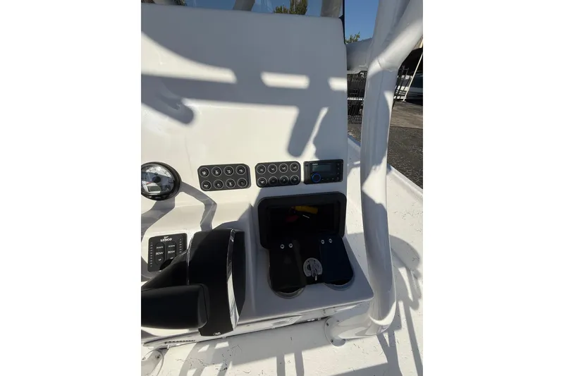 Slide: The Image of 2026 Blazer Bay 2400 boat dashboard with controls and gauges in sunlight. - 21
