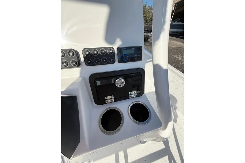 Slide: The Image of 2026 Blazer Bay 2400 boat console with controls and cup holders. - 22