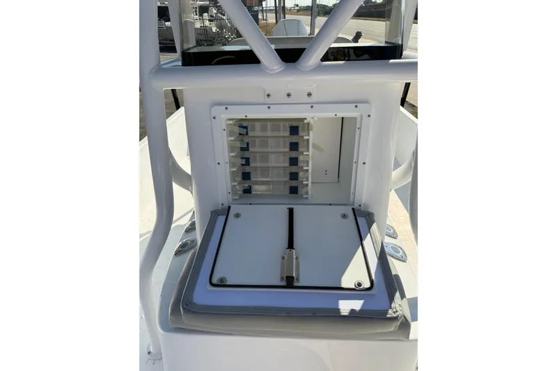 Slide: The Image of 2026 Blazer Bay 2400 boat console with storage compartments and rod holders. - 29