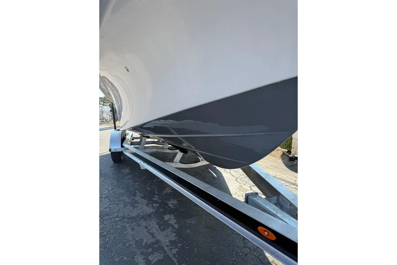 Slide: The Image of 2026 Blazer Bay 2400 boat on trailer, showcasing sleek hull design. - 36