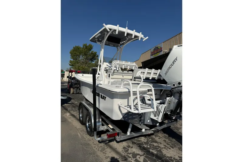 Slide: The Image of 2026 Blazer Bay 2400 boat on trailer with Mercury engine, parked outdoors. - 40