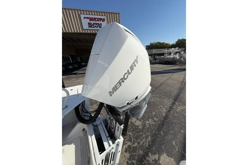 Slide: The Image of 2026 Blazer Bay 2400 with Mercury outboard motor at dealership. - 8