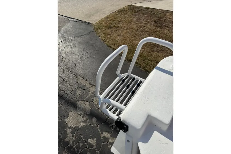 Slide: The Image of White Blazer Bay 2400 boat ladder, 2026 model, on cracked pavement background. - 9