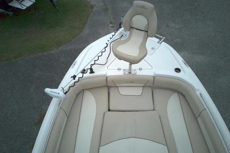 Slide: The Image of 2022 NauticStar 251 Hybrid boat with cushioned seating and mounted chair, top view. - 12