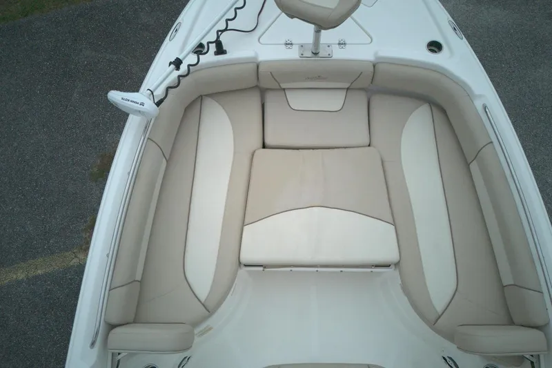 Slide: The Image of 2022 NauticStar 251 Hybrid boat interior with beige seating and trolling motor. - 13