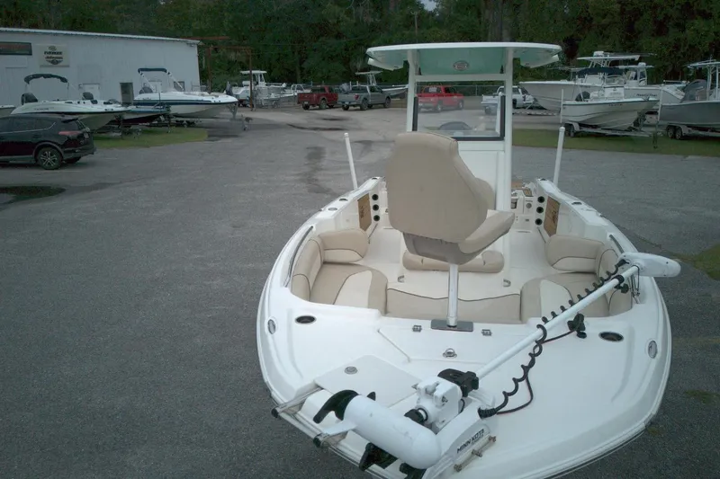 Slide: The Image of 2022 NauticStar 251 Hybrid boat with seating and trolling motor in a marina. - 14