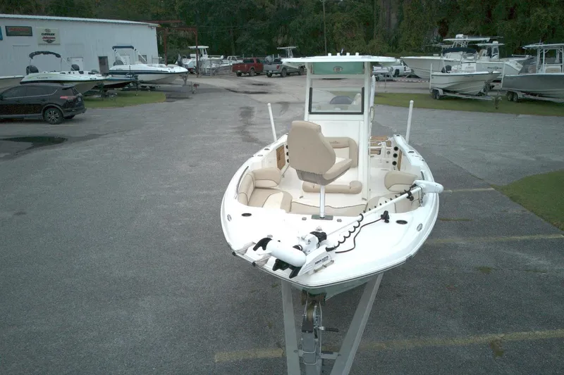 Slide: The Image of 2022 NauticStar 251 Hybrid boat displayed in a marina with other vessels. - 15