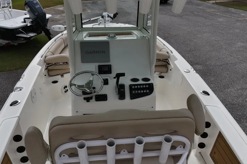 Slide: The Image of 2022 NauticStar 251 Hybrid boat interior with Garmin navigation system and steering console. - 2