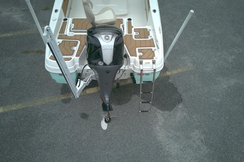 Slide: The Image of 2022 NauticStar 251 Hybrid boat with Yamaha 250 engine, ladder, and deck view. - 3