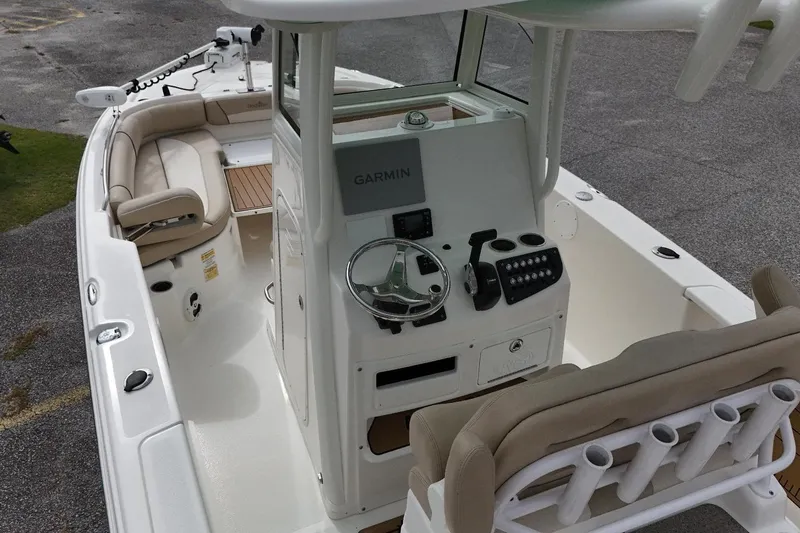 Slide: The Image of 2022 NauticStar 251 Hybrid boat interior with Garmin navigation system and seating. - 5