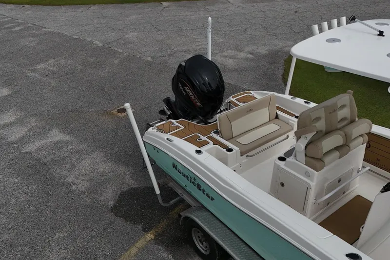Slide: The Image of 2022 NauticStar 251 Hybrid boat with seating and outboard motor on a trailer. - 6