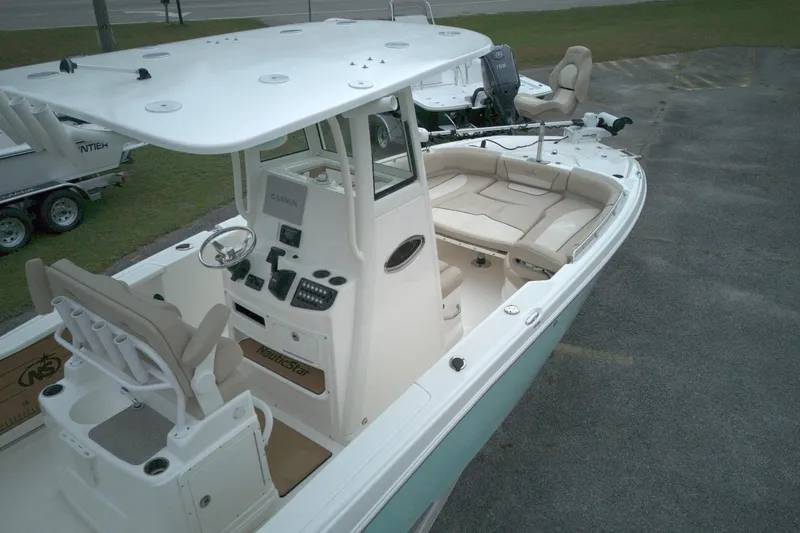 Slide: The Image of 2022 NauticStar 251 Hybrid boat with spacious seating and modern controls. - 8