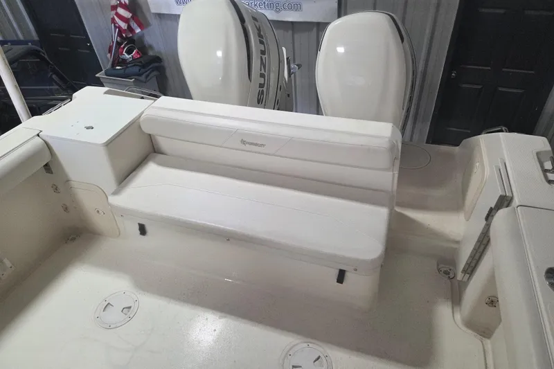 Slide: The Image of 2001 Pursuit 2870 Walkaround boat interior with seating and Suzuki outboard engines. - 13