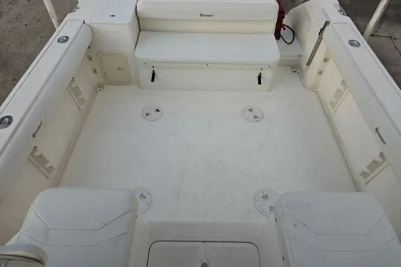 Slide: The Image of 2001 Pursuit 2870 Walkaround boat interior, featuring spacious seating and storage areas. - 5