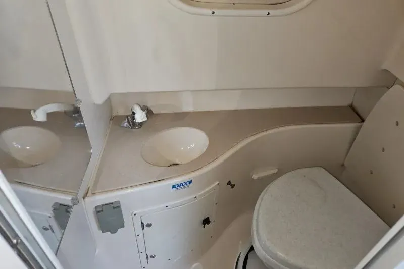 Slide: The Image of 2001 Pursuit 2870 Walkaround boat bathroom with sink and toilet. - 6