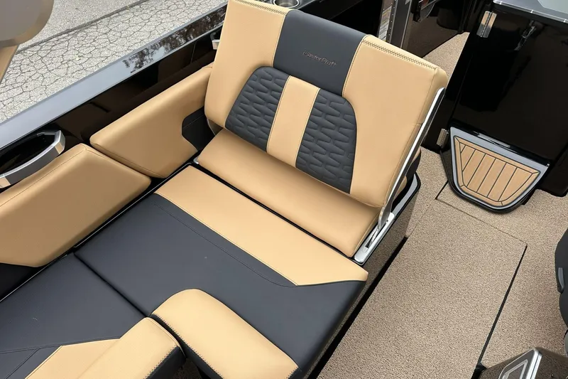 Slide: The Image of 2021 MasterCraft X26 boat interior with tan and black seating, showcasing luxury design. - 10