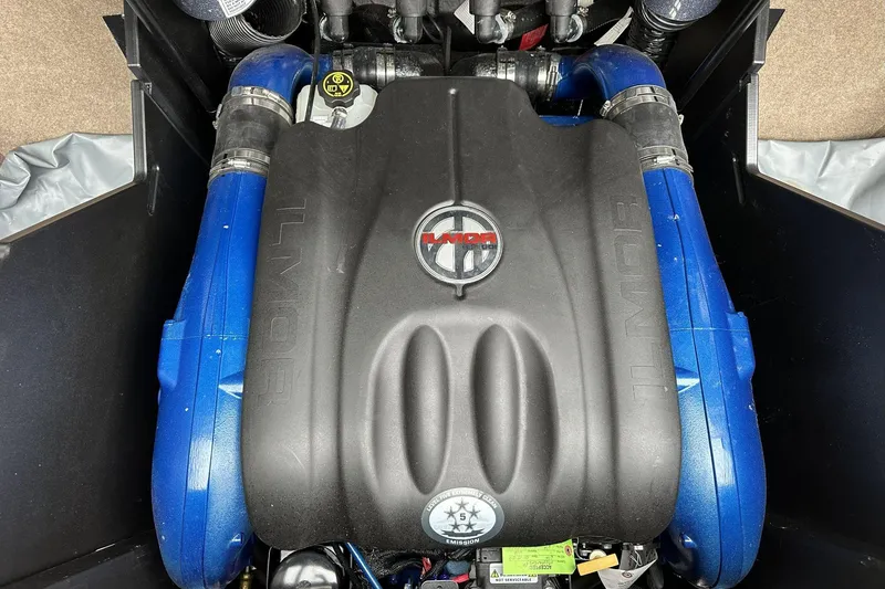Slide: The Image of 2021 MasterCraft X26 Ilmor engine with blue components and branded cover. - 11