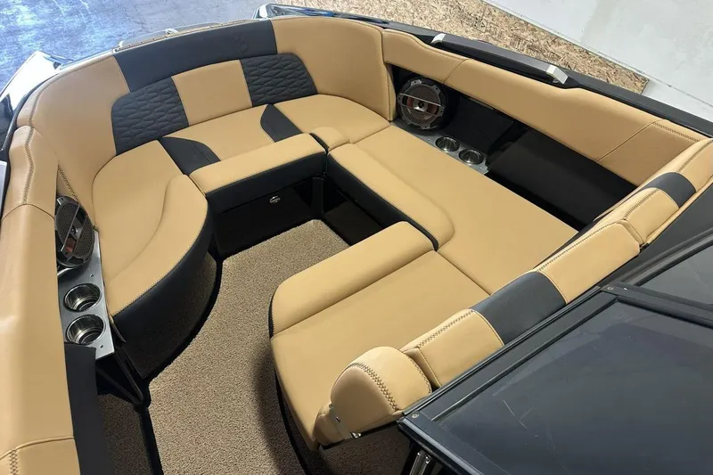 Slide: The Image of Luxurious interior of 2021 MasterCraft X26 boat with tan and black seating. - 2