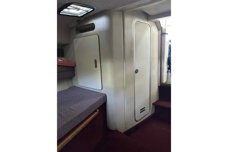 Slide: The Image of Interior of 1992 Sea Ray 300 Weekender boat, featuring cabin storage and seating. - 3