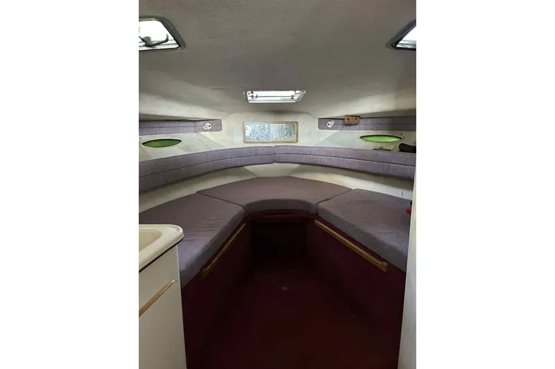 Slide: The Image of Interior cabin of 1992 Sea Ray 300 Weekender boat with cushioned seating. - 5